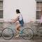 woman riding on teal cruiser bike near woman wearing pink long sleeved shirt